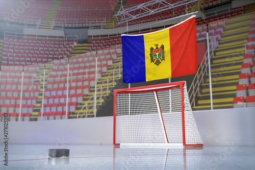 Flag of Moldova in hockey arena with puck and net