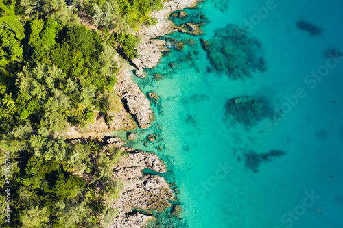 View from above, stunning aerial view of a tropical coast bathed by a turquoise clear sea. Phuket, Thailand.