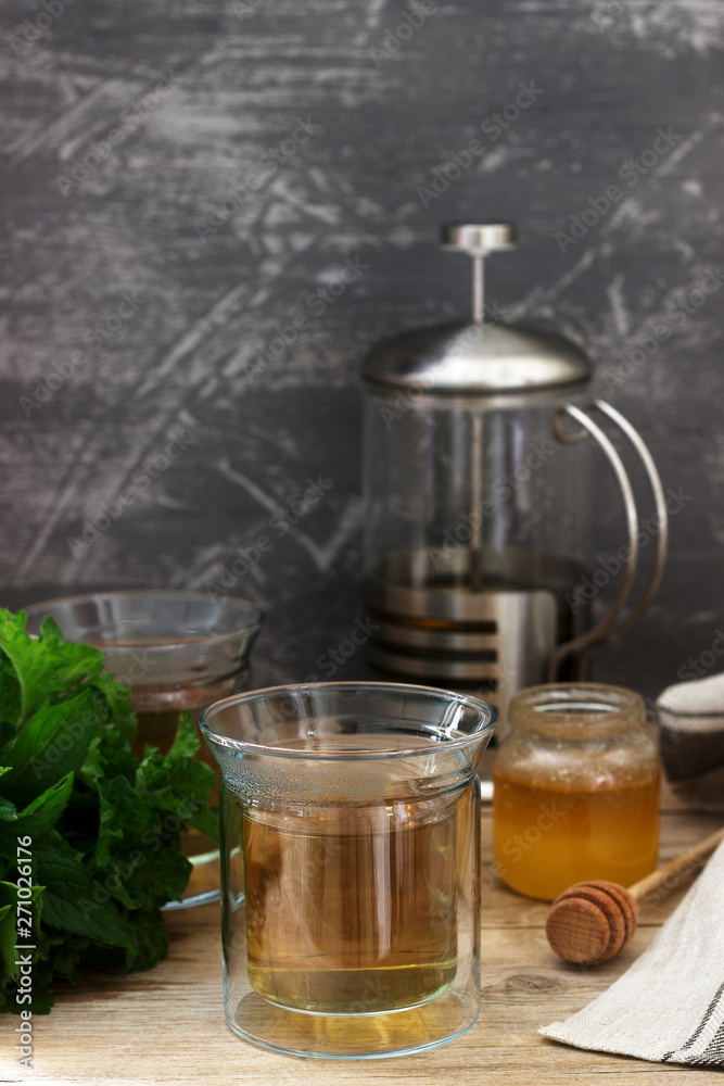 Herbal tea made from mint and lemon balm with honey in glass cups. Rustic style. Herbal tea made from mint and lemon balm with honey in glass cups. Rustic style.