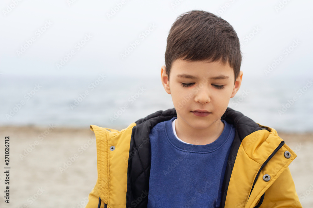 portrait of a pensive boy against the sea portrait of a pensive boy against the sea