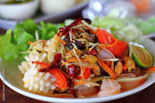 A delicious spicy papaya salad with seafood in thaifood