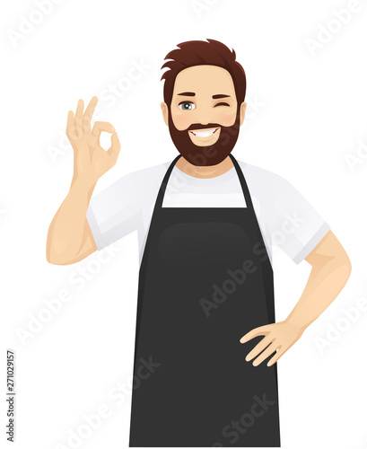 Handsome man in black apron gesturing ok sign isolated vector illustration