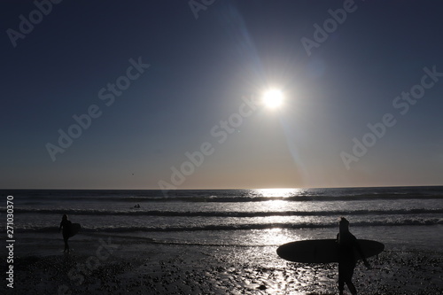 surfer on beach and sunset