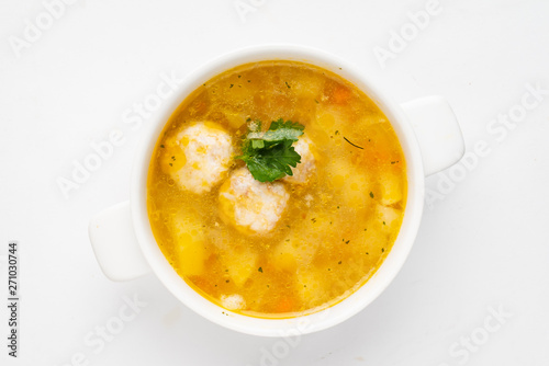 soup with meatballs on the white background, top view