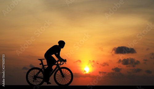 Cycling Silhouette on sunrise background © rathchapon