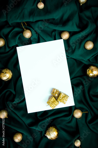 Green color Christmas and new year Decorative background, blank white greetings paper with golden balls
