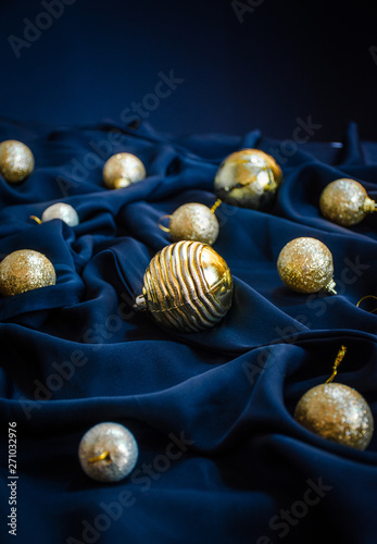 New year background blue color silk cloth with golden Christmas tree ball