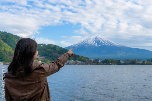 Young girl Backpackers traveling Beautiful Fuji Mountain, Women Backpacking Fujisan volcano at Kawaguchiko lake, Japan.