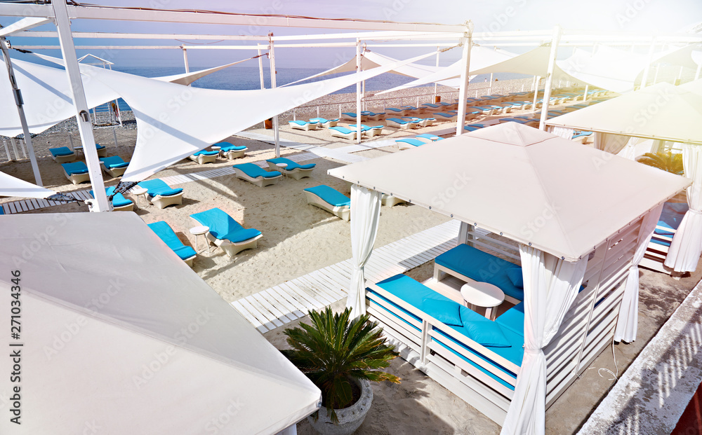 Fototapeta premium Sun beds on sandy beach