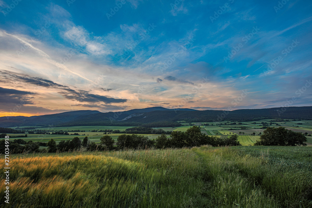 green hills and sunset sky