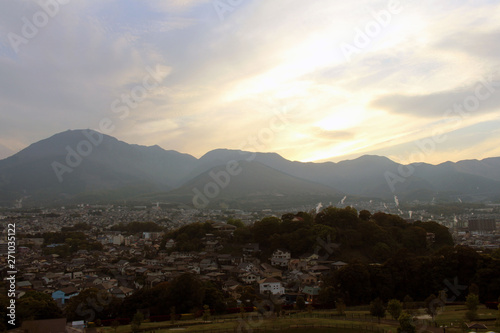 The landscape of Beppu in Oita and golf range as seen from a hill in sunset © leodaphne