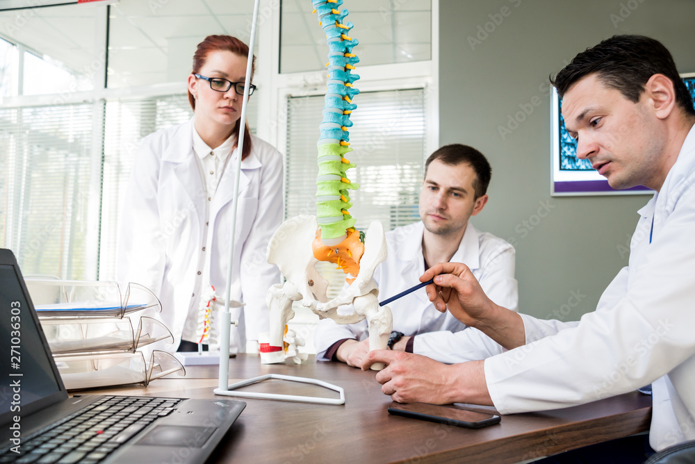 Fototapeta premium Doctors team having medical council in hospital. Discussing medical issues. Spine fixation systems