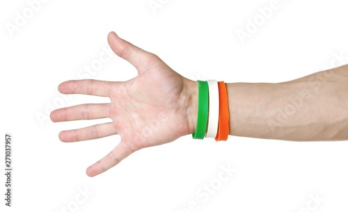 Colored rubber bracelets on the arm. Close up. Isolated on white background