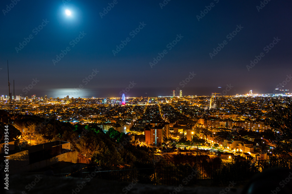 Barcelona skyline panorama at night from Turo Rovira, Catalonia, Spain.