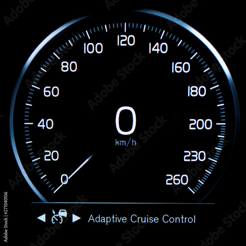 Close up of circular car speedometer with Adaptive Cruise Control (ACC) light indicator. Modern digital car display showing turn on the cruise control mode.