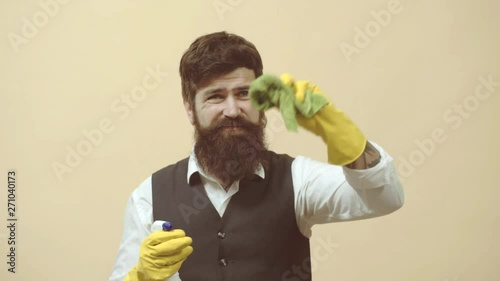 Cleaning service. Man with cleaning agents working. Portrait of man with cleaning equipment cleaning the house. Portrait of a bearded man with sponge and spray ready to clean windows. photo