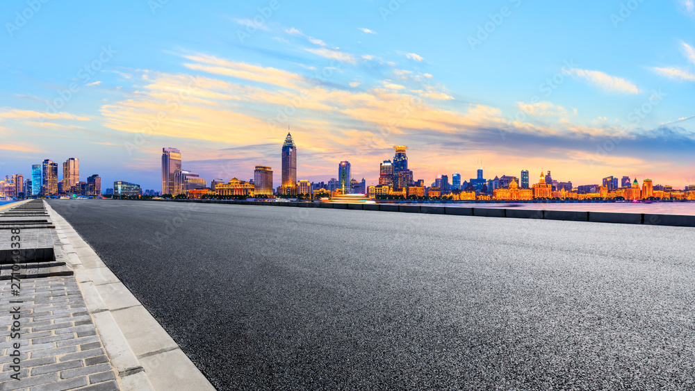 Shanghai city skyline and empty asphalt highway at sunset