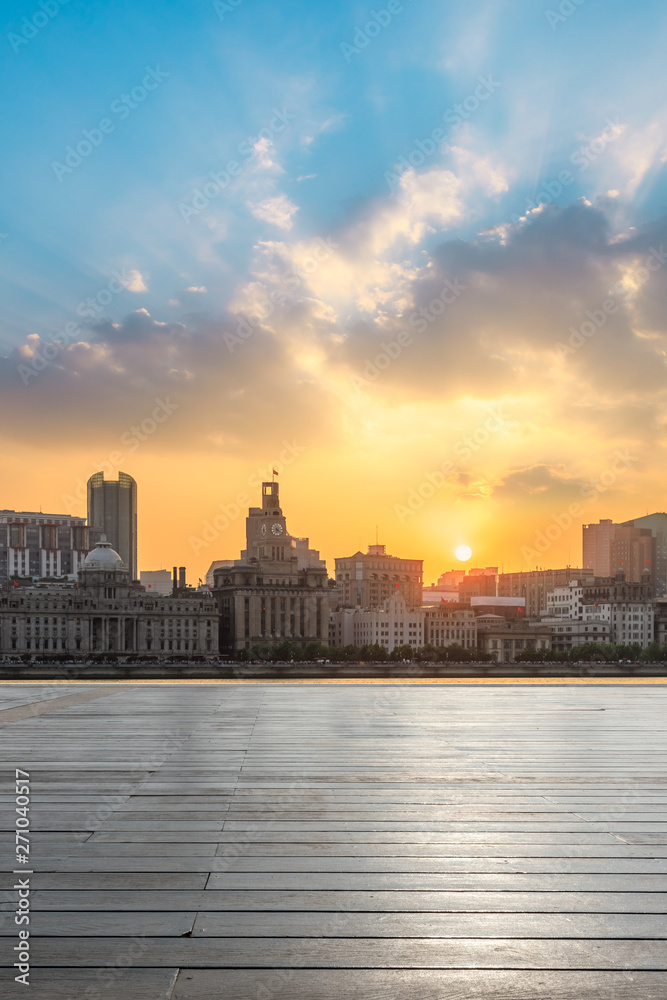 Shanghai bund city skyline and wooden square at sunset