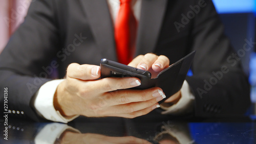 Businessman with french manicure using smartphone