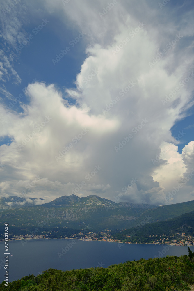a large cloud over Petrovac, a blue sky on a bright sunny day, a cloud obscured the sun