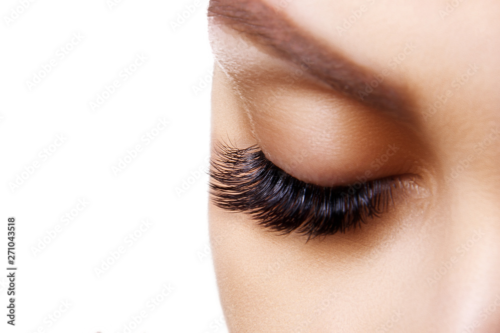 Fototapeta premium Eyelash Extension Procedure. Woman Eye with Long Blue Eyelashes. Ombre effect. Close up, selective focus.