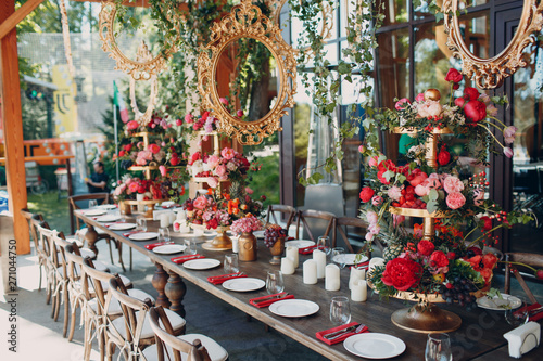 Fototapeta Naklejka Na Ścianę i Meble -  Wedding table flowers with fruits and berries decor in red white pink green colors.