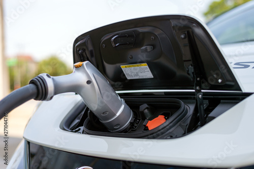 closeup charger battery for electric car with soft-focus and over light in the background