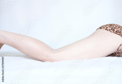 Beautiful body woman relaxing on the bed and Young woman in underwear on white silk bed