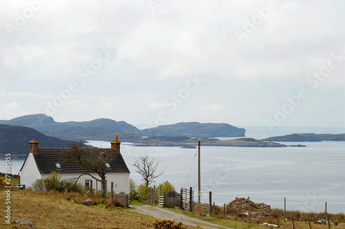 Roadside cottage at Coigach, Wester Ross, with the Summer Isles behind