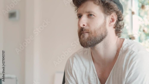 man plays with a game controller whiile siting on the couch at home photo