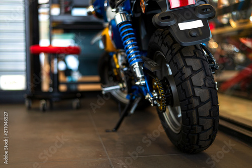 the rear of the classic motorcycles standing in repair shop with soft-focus and over light in the background © memorystockphoto