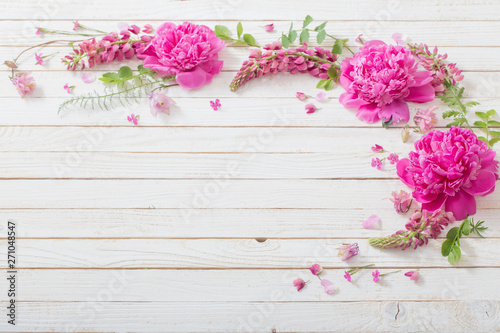 pink beautiful flowers on white wooden background