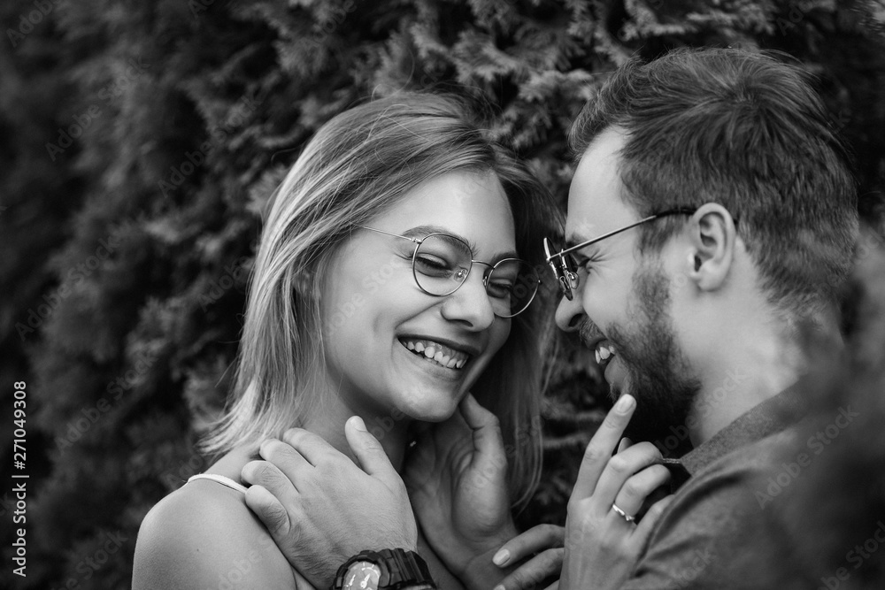 Happy and young couple in love smiling after kiss. Black and white photo Happy and young couple in love smiling after kiss. Black and white photo