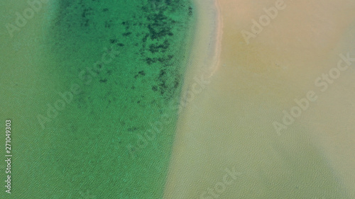 Aerial drone bird's eye view photo of tropical caribbean paradise bay and lagoon with white sandy beach and turquoise clear sea © aerial-drone