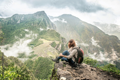 Girl-hiker looking on top of Huayna Picchu, looking on Machu Picchu photo