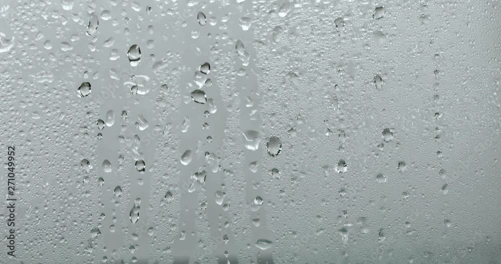close up a steam mirror with rain drop on the glass window , rainy season background close up a steam mirror with rain drop on the glass window , rainy season background