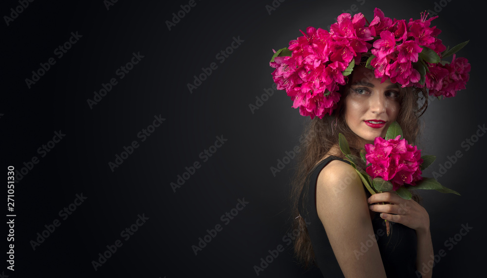 Naklejka premium Portrait of attractive young woman with long curly hair and wreath on a head.