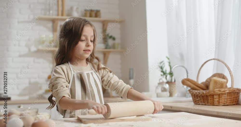 Cute caucasian girl is learning how to cook, preparing dough for cookies, dreaming of becoming a chef - childhood dream, childhood memories concept 4k Cute caucasian girl is learning how to cook, preparing dough for cookies, dreaming of becoming a chef - childhood dream, childhood memories concept 4k