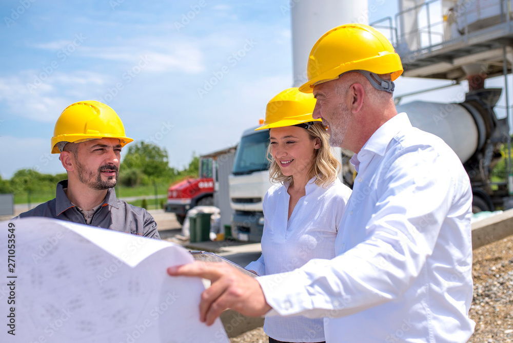 Group of engineers on site, visiting ready mix concrete plant and discussing construction plan Group of engineers on site, visiting ready mix concrete plant and discussing construction plan