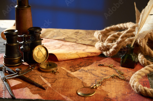 Compass with clock and various objects lying on the map