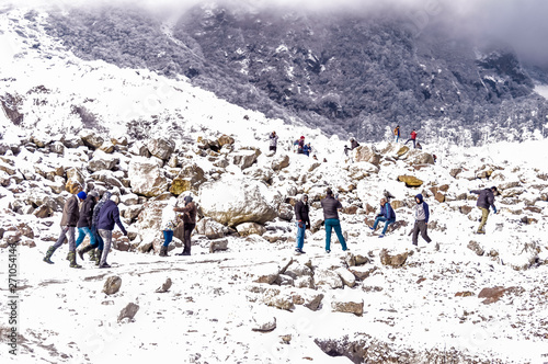 Auli, Himachal Pradesh, India December 2019 - People enjoying fresh snowfall. Normal life came to a standstill in Valley with heavy snowfall which suspended road, rail and air traffic to this region. photo