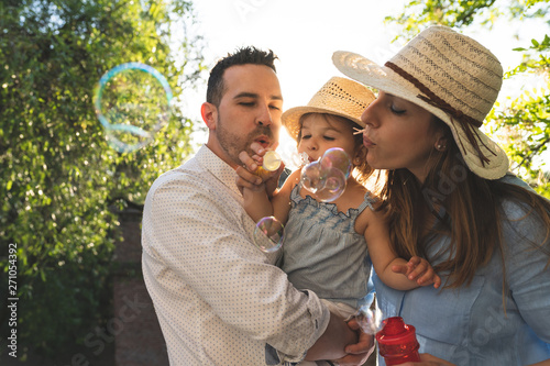 Happy Hispanic Family Having Fun Together Outdoors.
