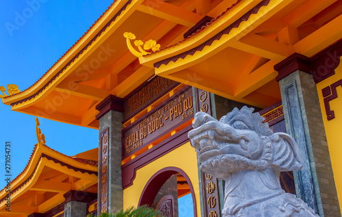 CloseUp of Ho Quoc Pagoda and big dog dragon head. The biggest ancient Buddhist temple in Phu Quoc Island, Vietnam. Text over entrance 