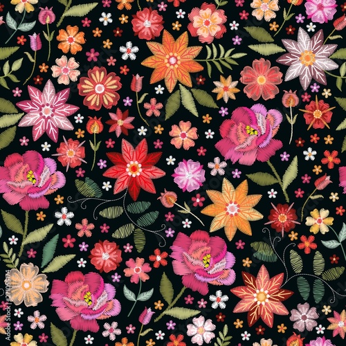 Embroidery seamless pattern with bright flowers on black background. Fashion design for fabric, textile, wrapping paper. Fancywork floral print.