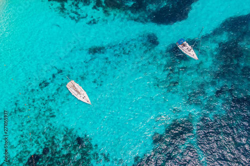 White yacht coral reef in Beautiful bay sea. Aerial top view