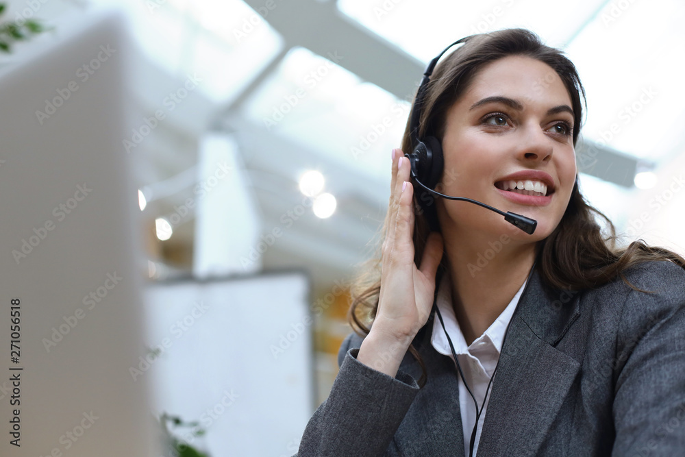 Female customer support operator with headset and smiling. Female customer support operator with headset and smiling.