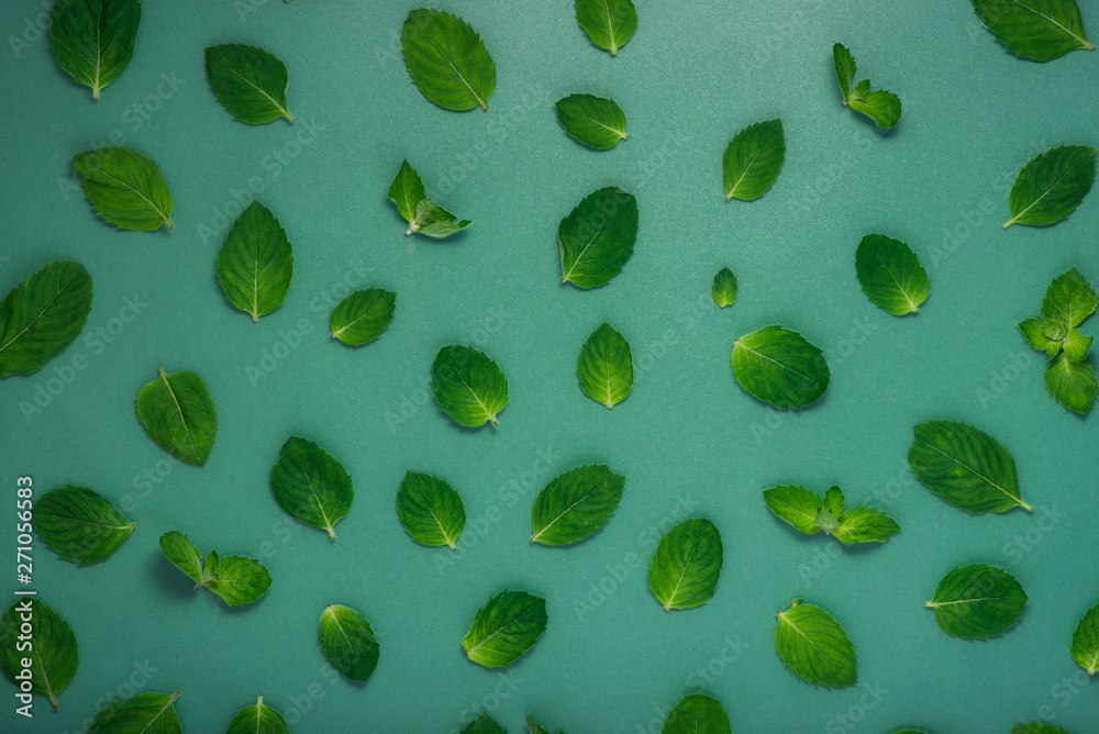 Fresh mint leaves on green background Fresh mint leaves on green background