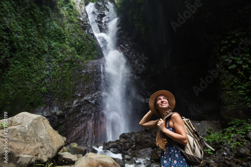 Fototapeta Naklejka Na Ścianę i Meble -  Woman near waterfal on Bali, Indonesia 