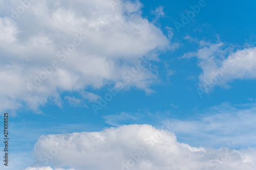 Blue sky with fluffy clouds. Natural landscape. Spring nature scene.