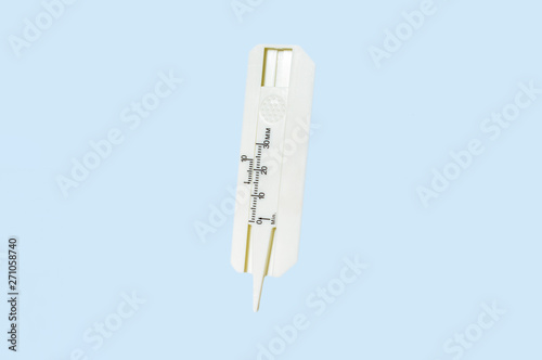 Close up of Tire tread depth gauge isolated on background.